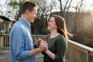 A couple holding hands and smiling, symbolizing strength and unity after overcoming a crisis