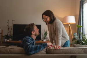 A Kodak-quality realistic image of a couple having a calm and constructive discussion at home, with a warm and empathetic atmosphere