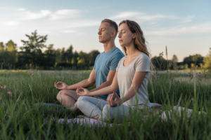 Couple meditating together outdoors