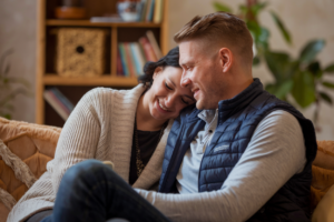 A Kodak-quality realistic image of a couple reconnecting offline, enjoying quality time together without any digital devices, in a warm and cozy setting.